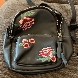 Backpack—small.  Black with maroon and pink flowers.